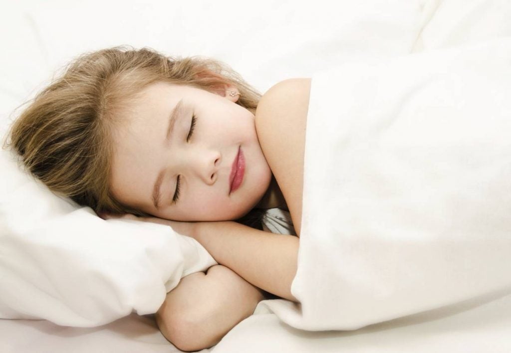 A young girl sleeping happily and soundly after being in the Stay Dry at Night program to stop bedwetting