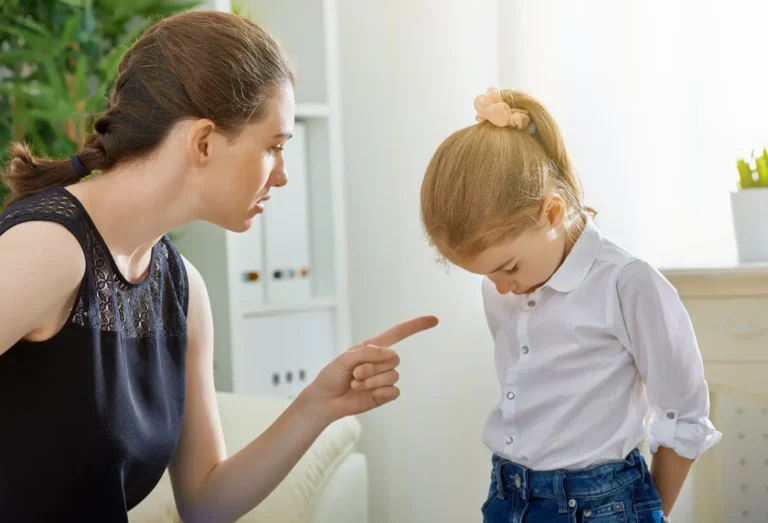 Mother reacting to child after a poop accident, highlighting the emotional toll of soiling in underwear from overflow incontinence.