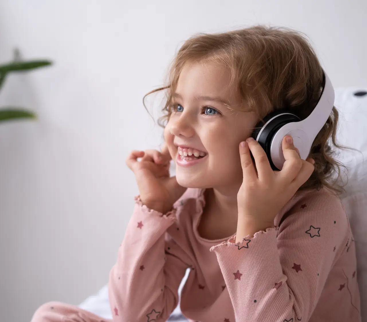 Child listening to a guided audio recording with headphones