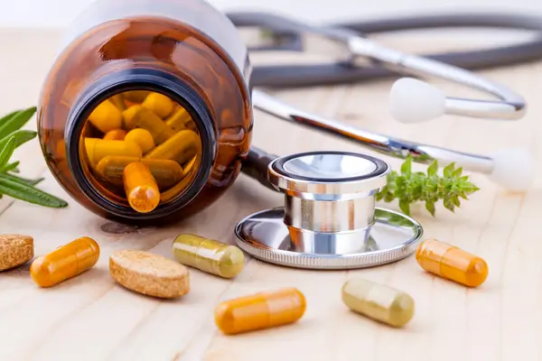 Vitamin supplements beside a stethoscope, representing research into vitamins linked to bedwetting in children