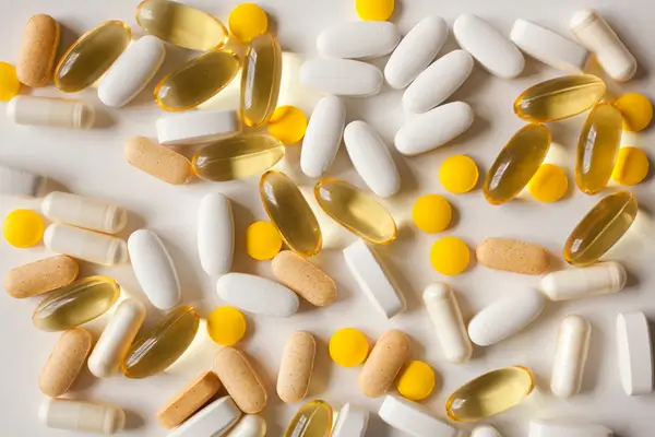 Assorted vitamin tablets and capsules representing research into vitamin D, vitamin B12, Omega-3 and bedwetting